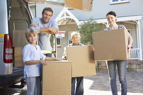 Moving truck and packed boxes during a flat removal service in Brentpark