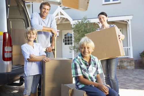 Professional movers handling household items in Brentpark